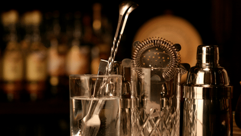 Philly Yard Bar March 2023 pic, showcase of muddler, glass, and shaker, blurred background